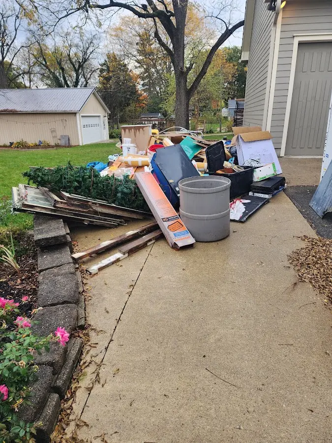 Dumpster being loaded with debris for Residential Dumpster Rental in Dumas